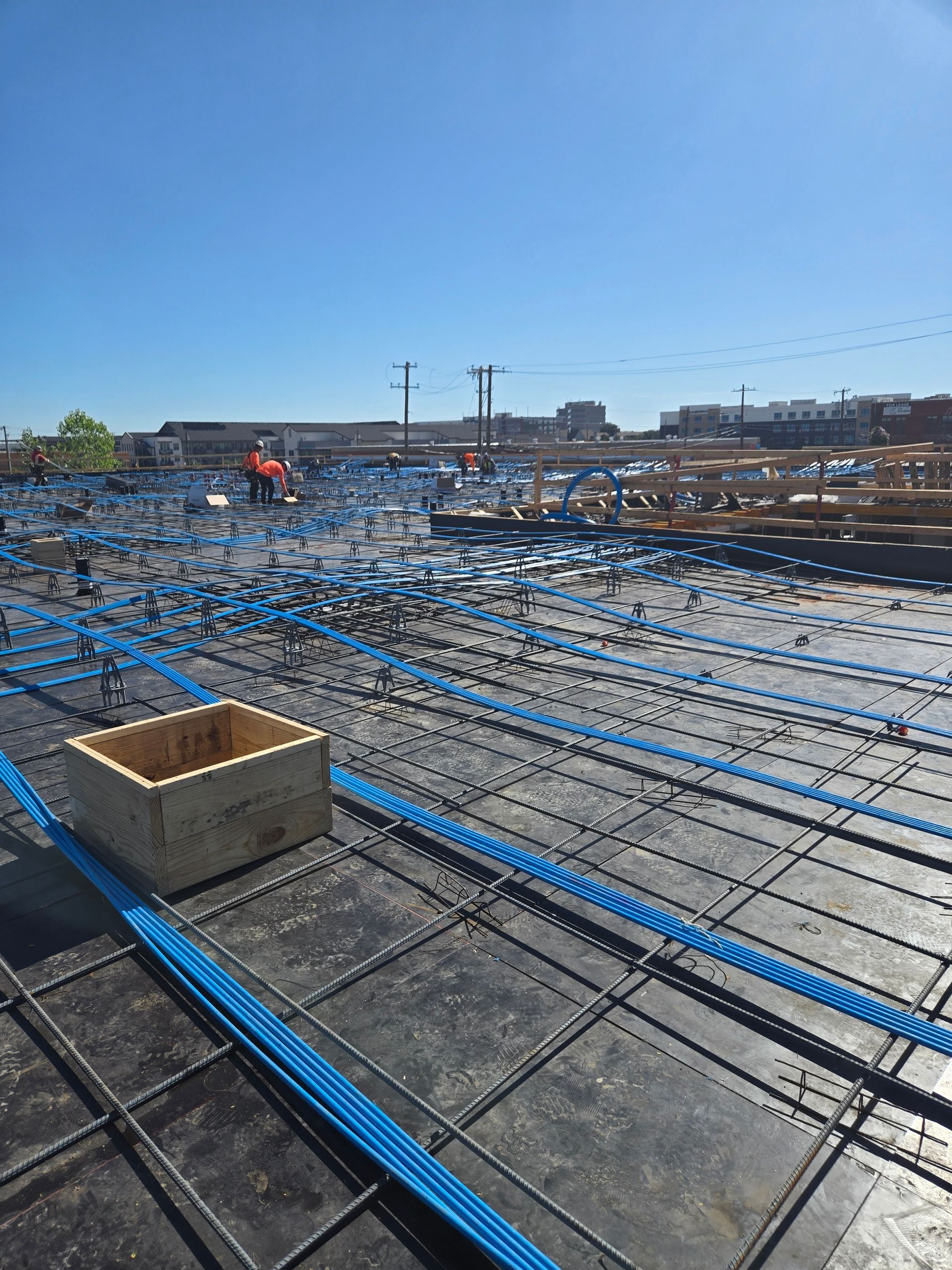 A construction site with a lot of wires and a box on the ground.