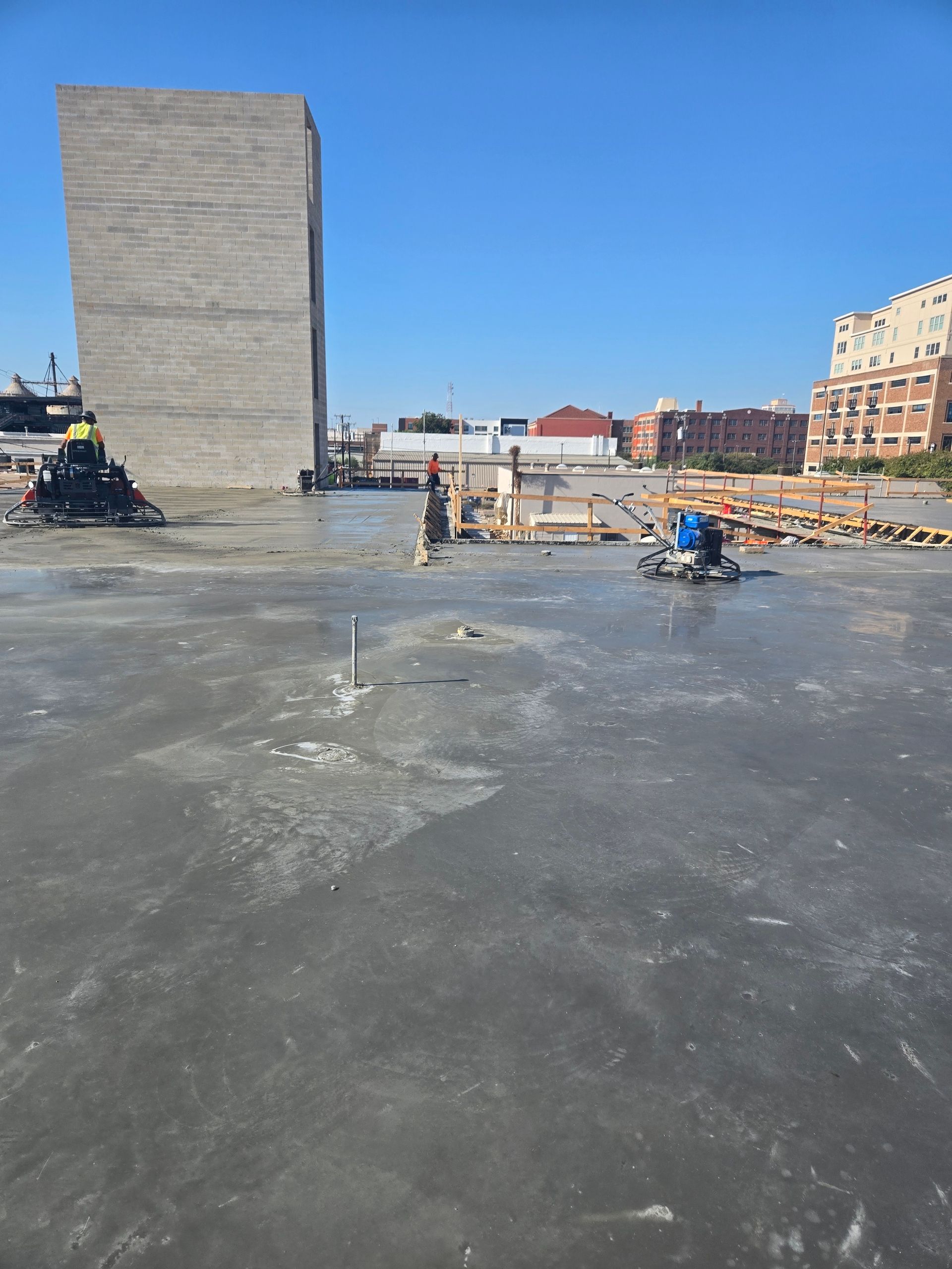 A construction site with a large building in the background