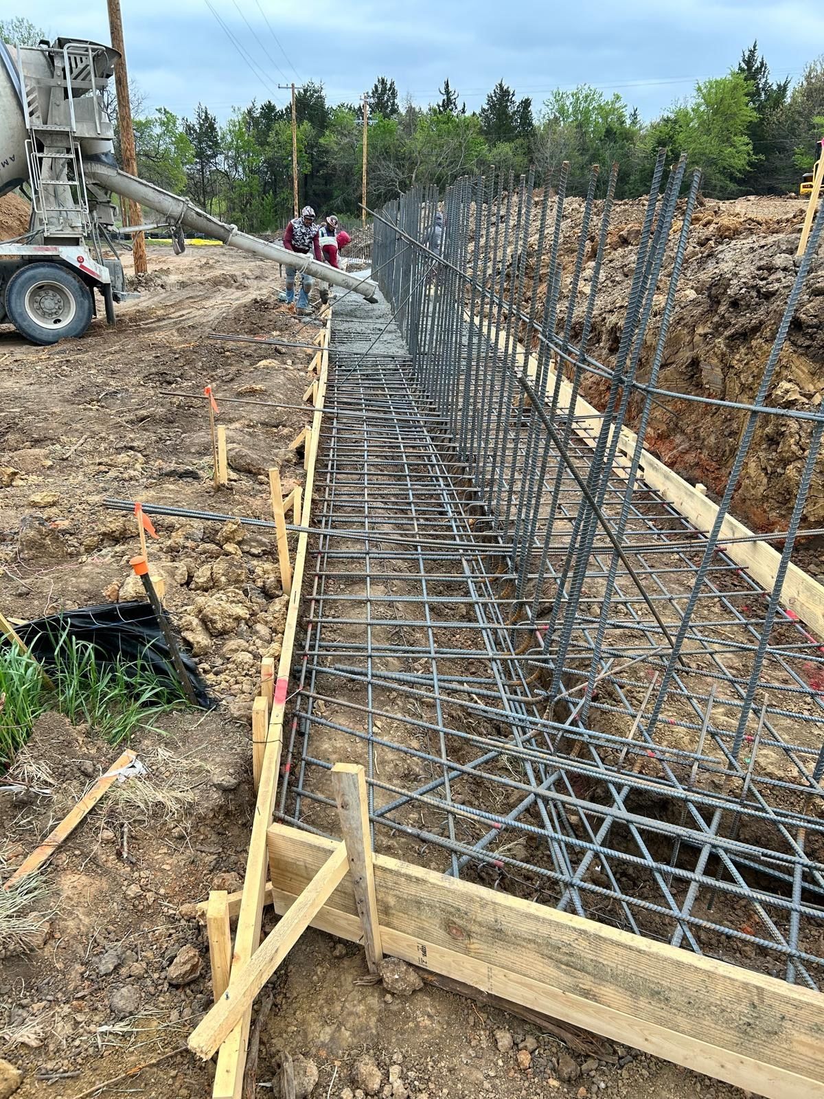 Construction site with rebar and wooden formwork for a concrete foundation trench