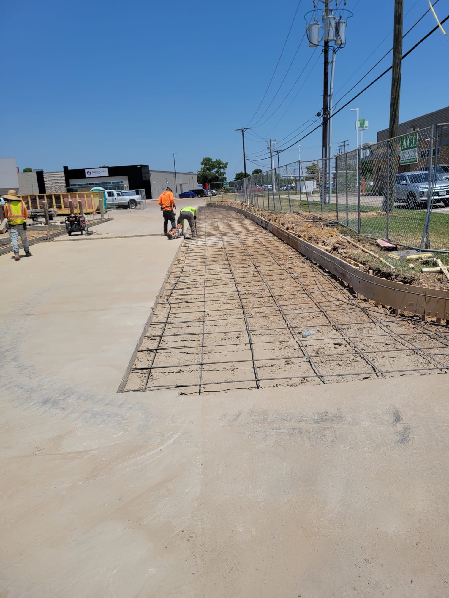 A group of construction workers are working on a road.