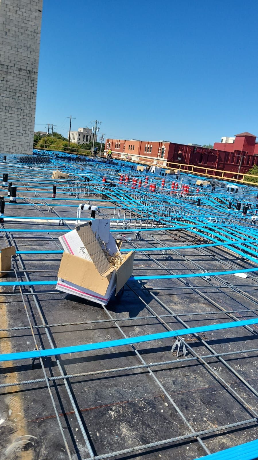 A cardboard box is sitting on top of a construction site.