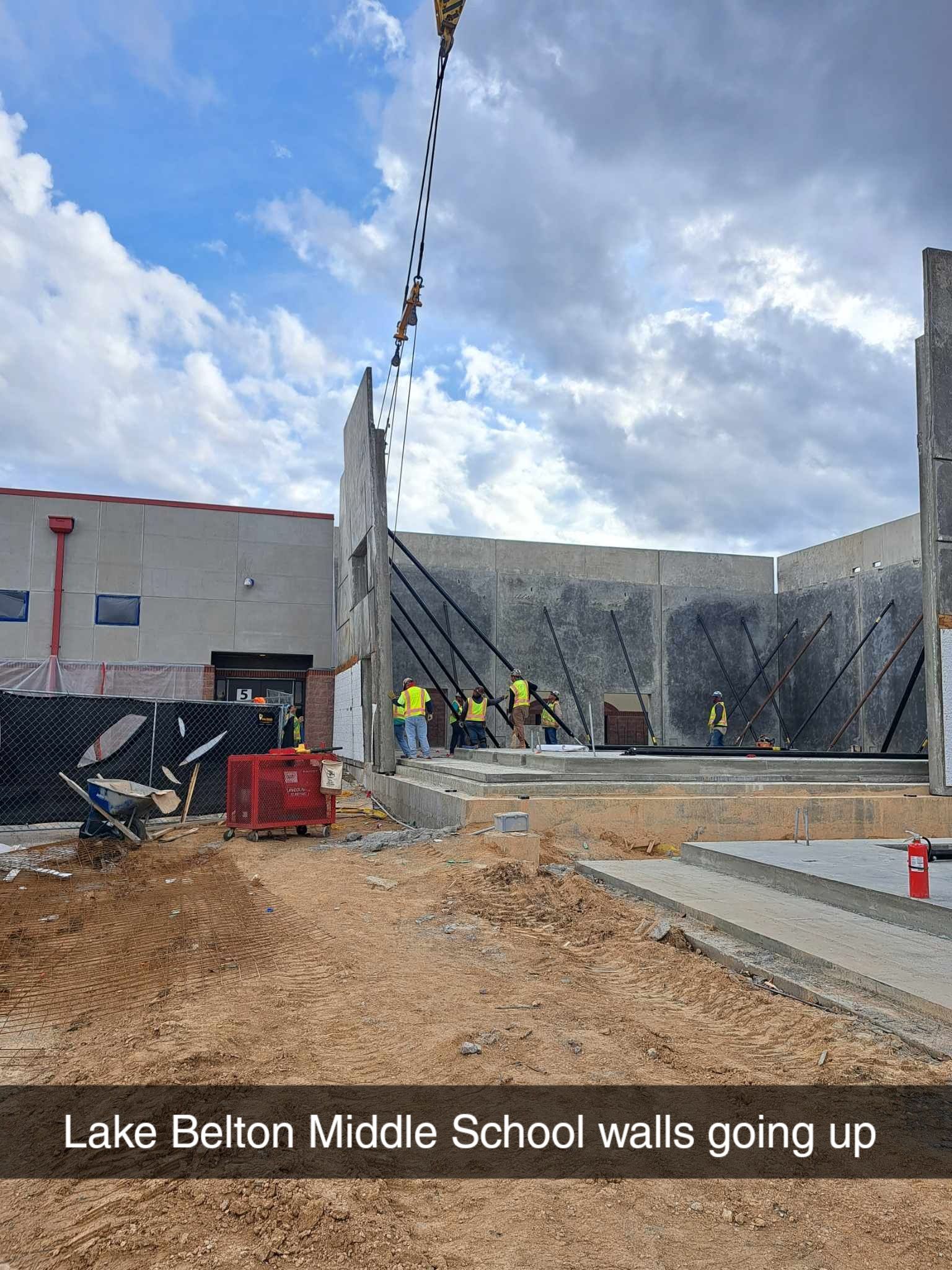 A group of construction workers are working on a building.