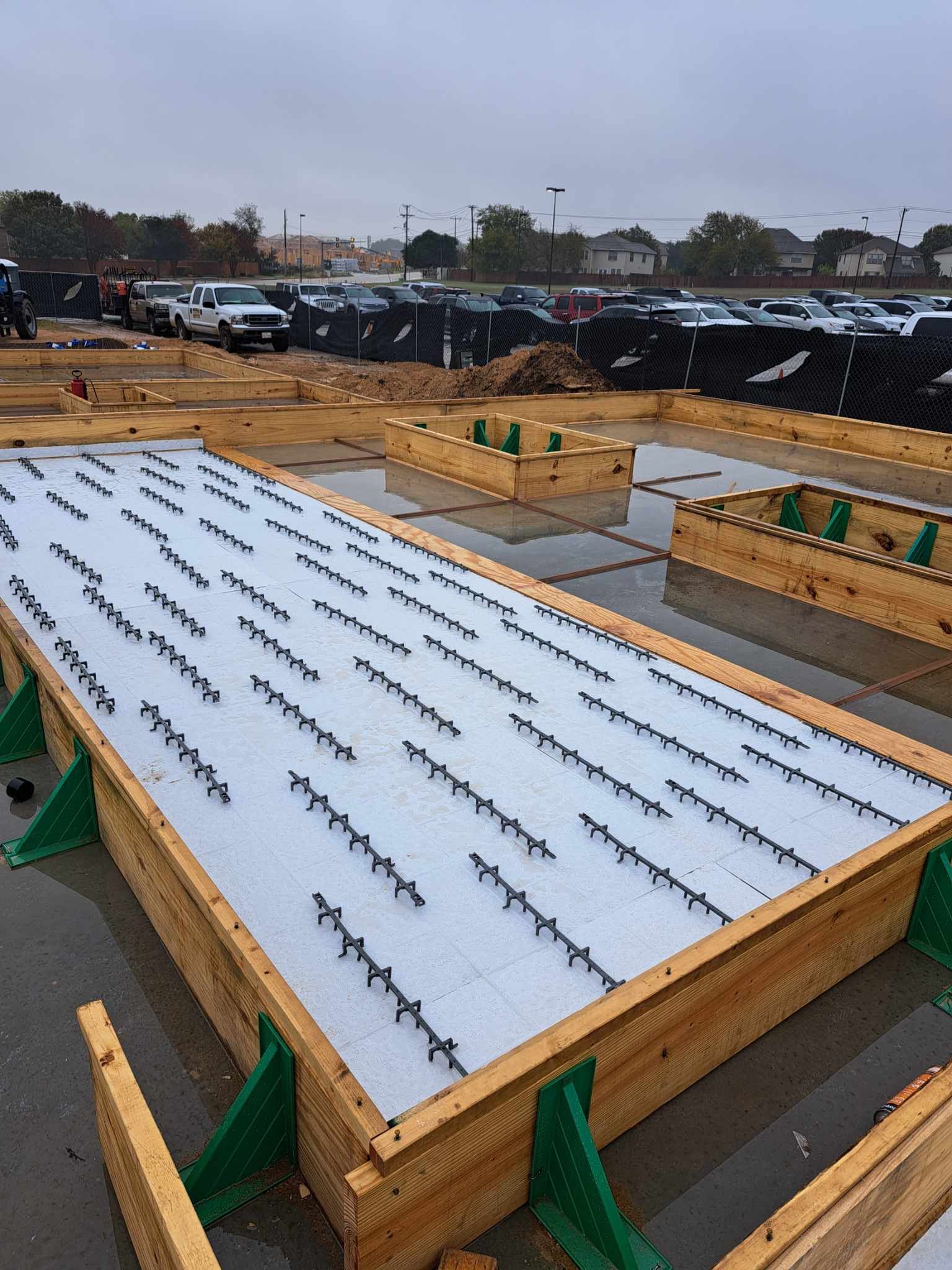 A large wooden box is sitting in the middle of a parking lot.