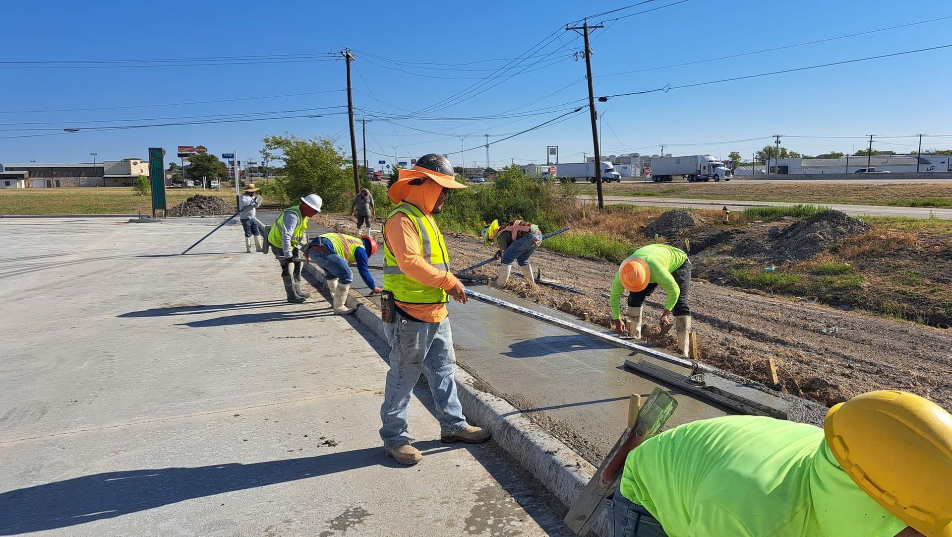 A group of construction workers are working on a road.