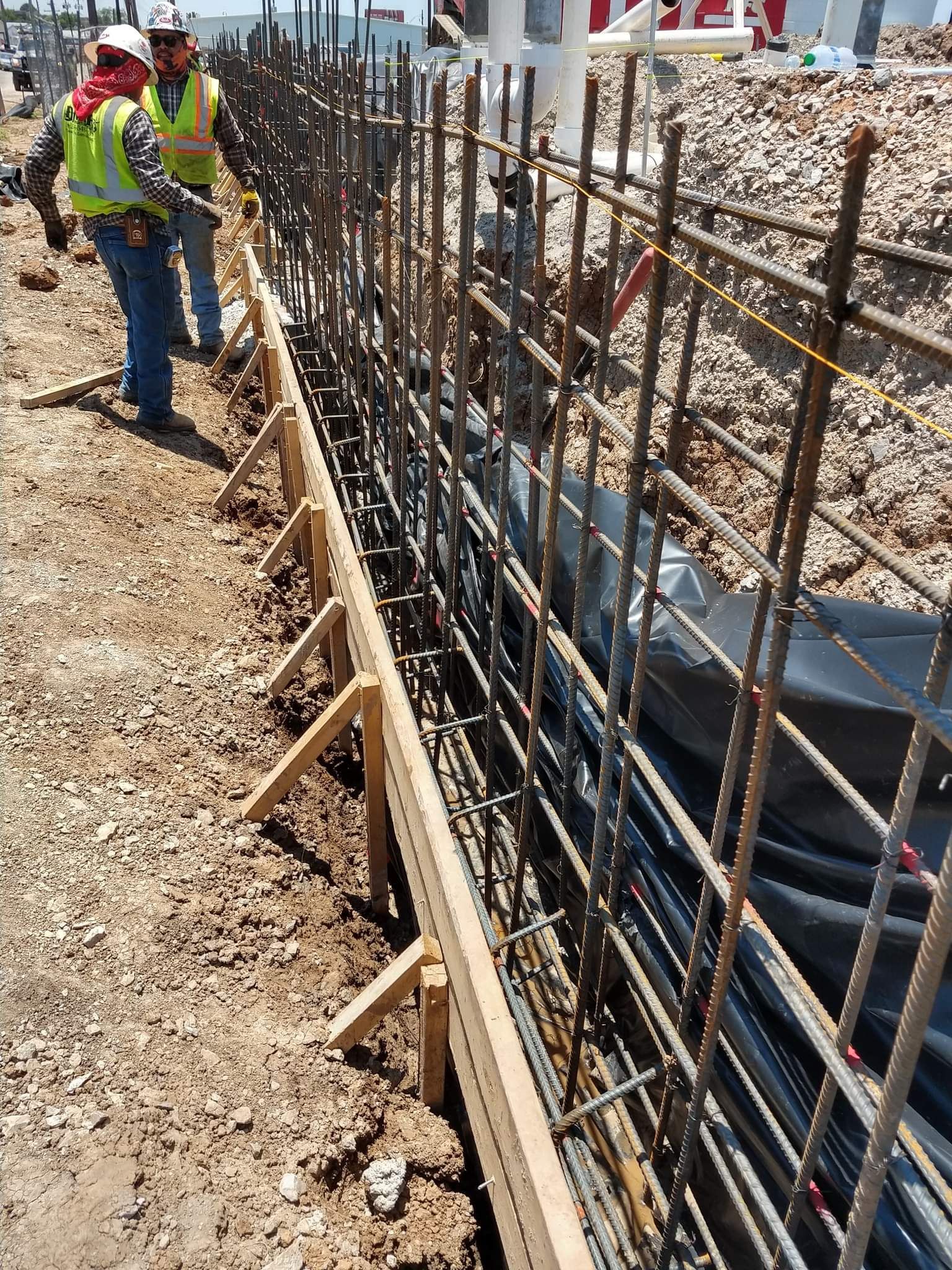 A group of construction workers are working on a construction site.