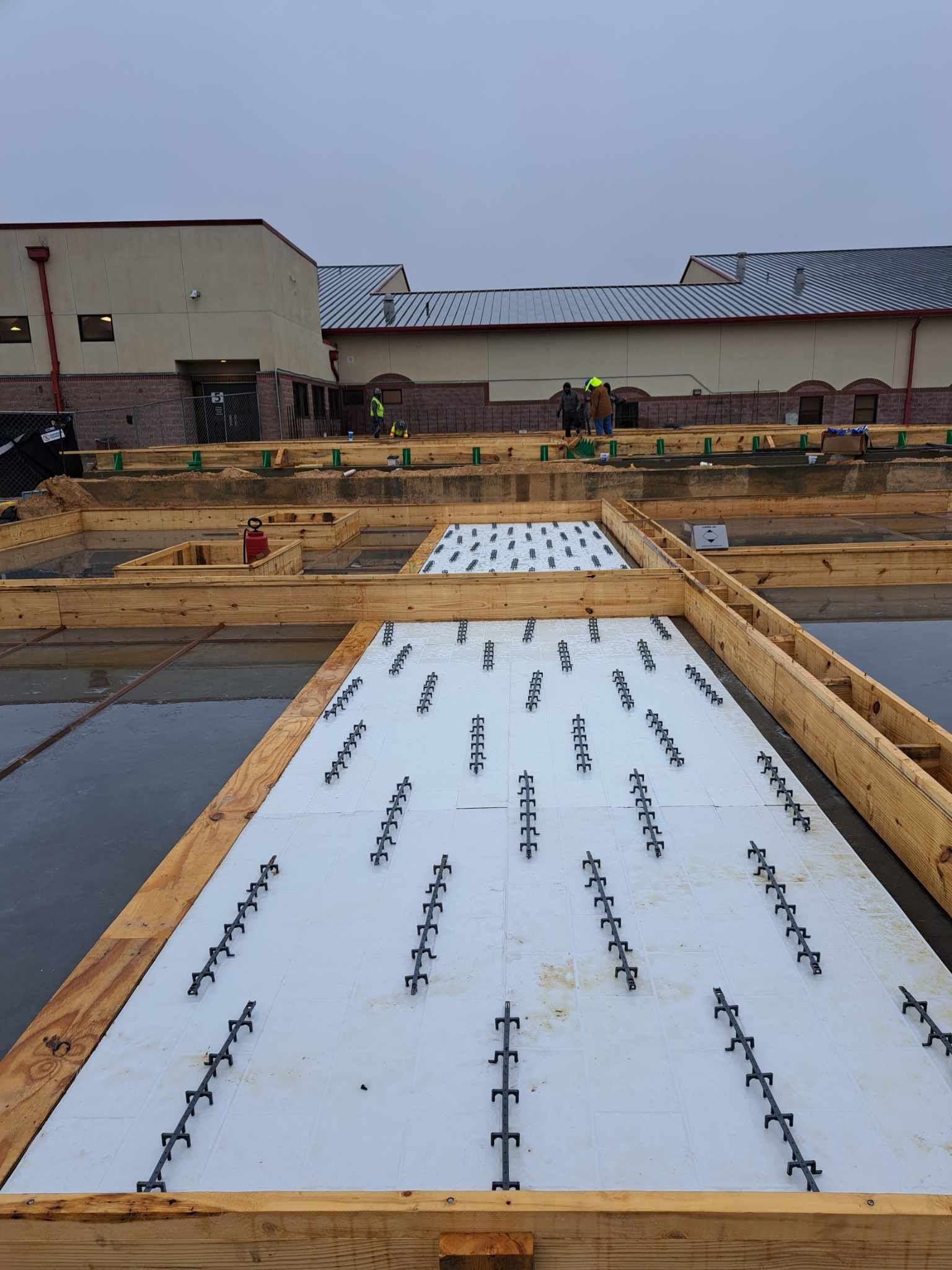 A construction site with a large building in the background