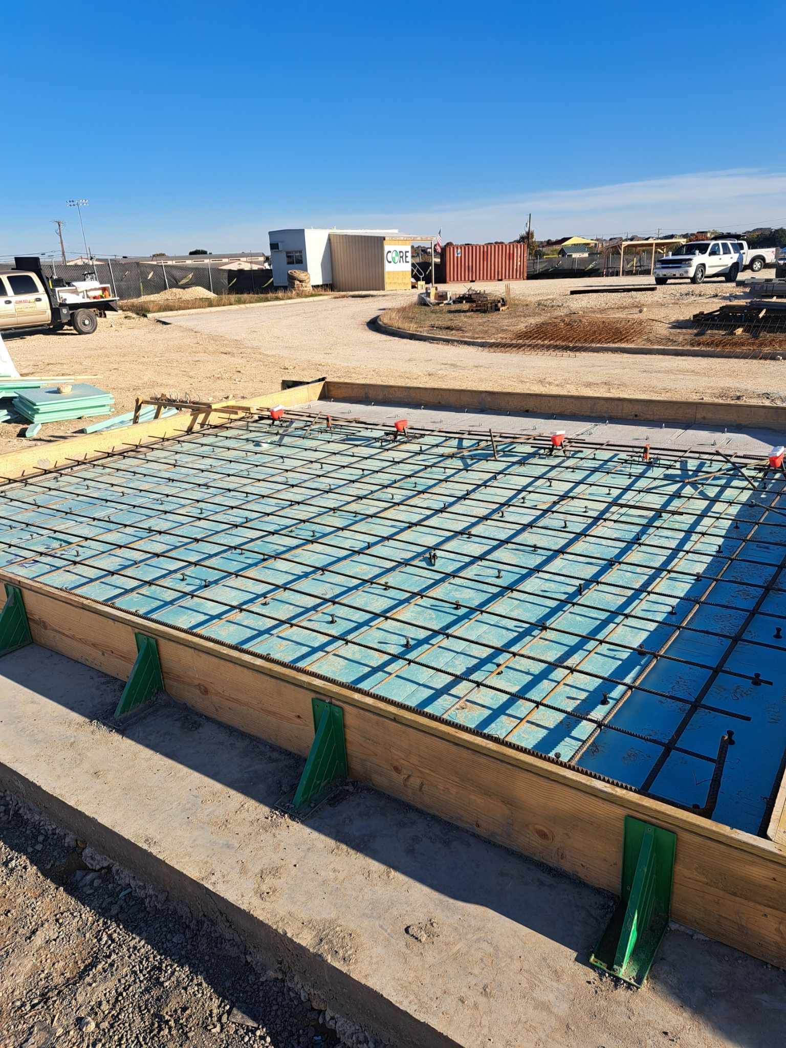A concrete slab is being built on a construction site.