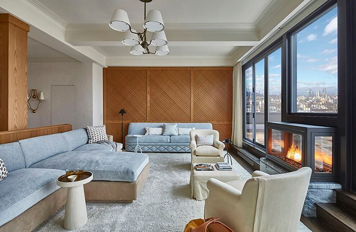 A living room with a couch , chairs , and a fireplace.