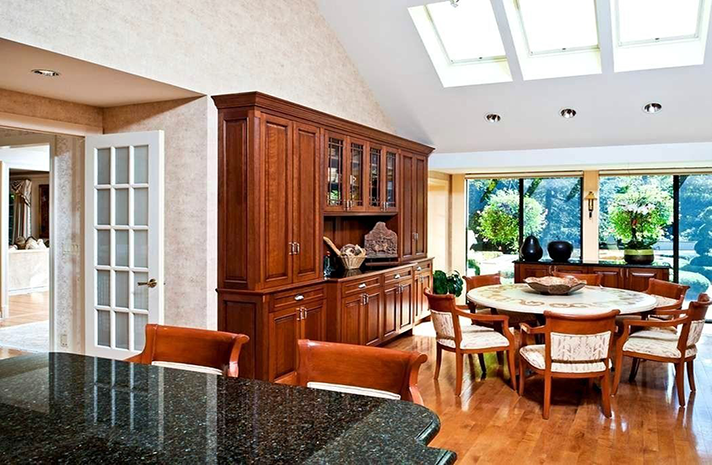 A dining room with a round table and chairs