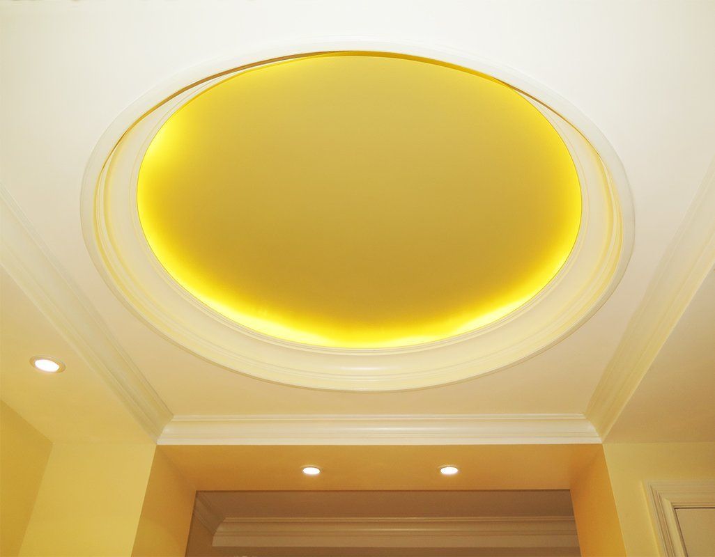 A ceiling with a yellow circle in the middle of it