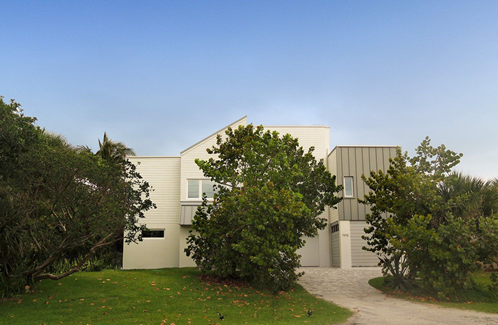 A large white house with trees in front of it