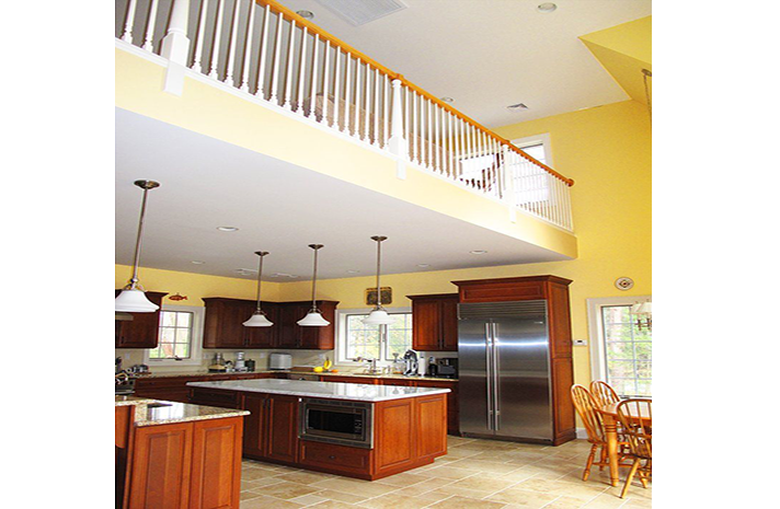 A kitchen with a large island and stainless steel appliances