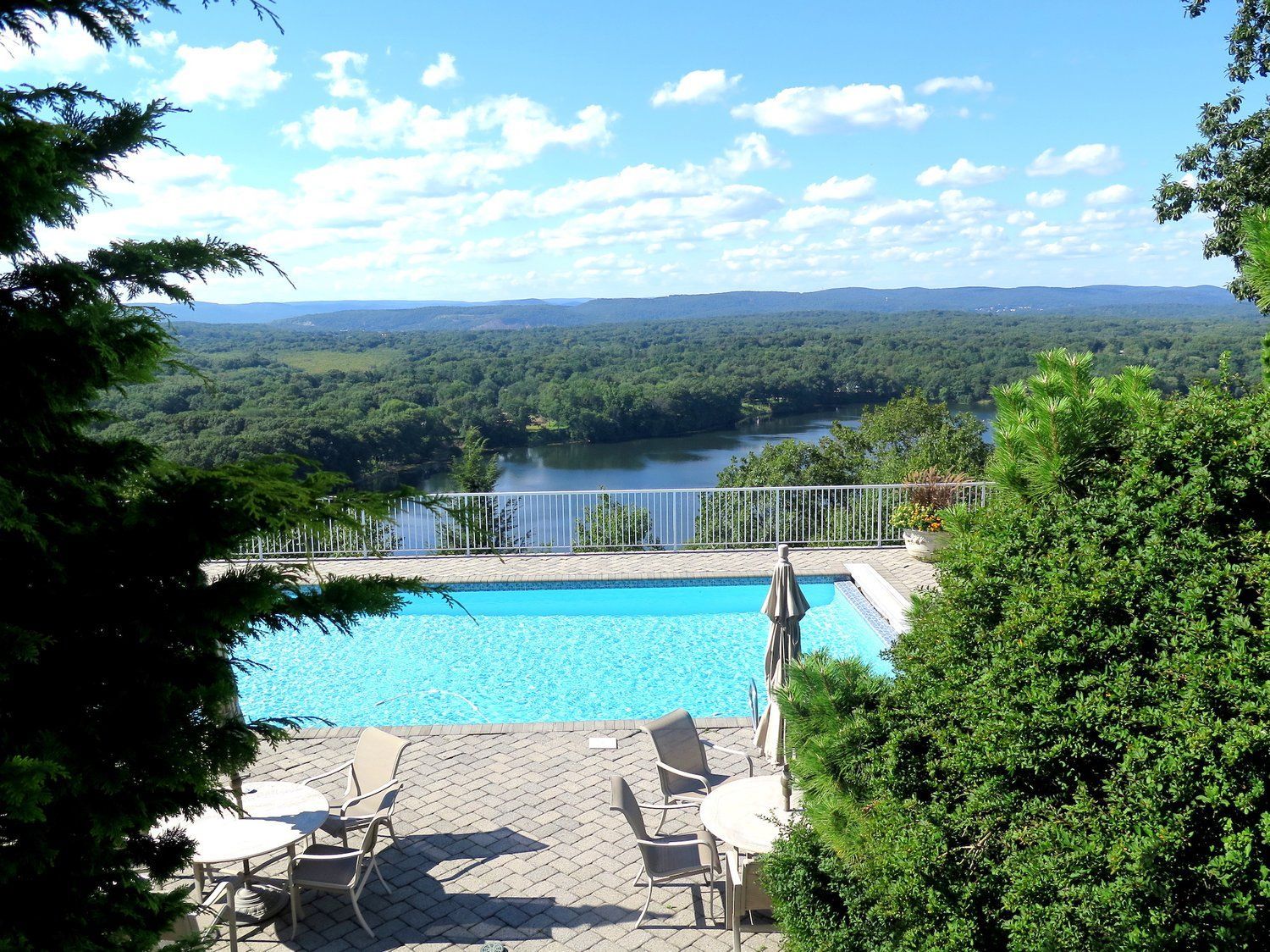 A large swimming pool with a view of a lake