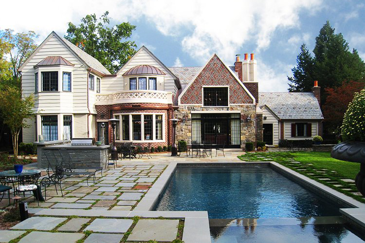 A large house with a large swimming pool in front of it