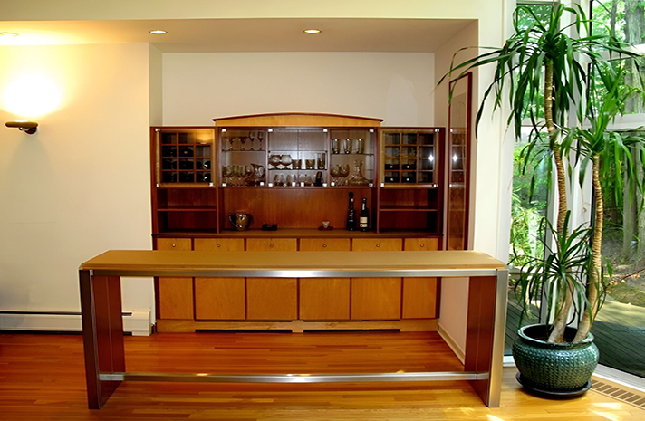 A room with a bar and a plant in front of it