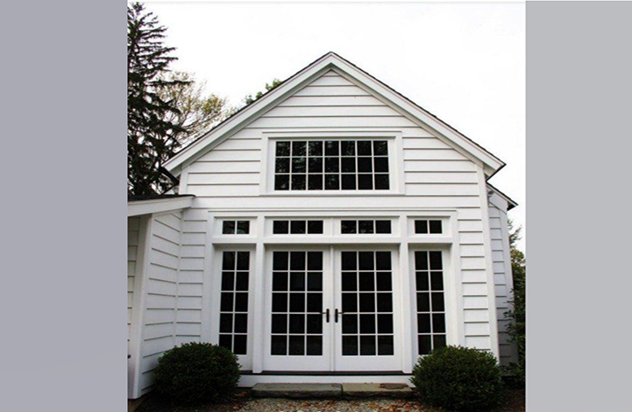 A white house with a lot of windows and doors