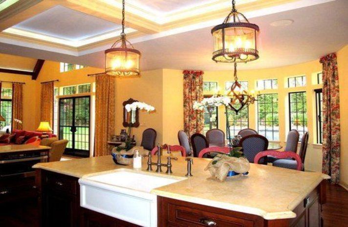 A kitchen with a sink and a chandelier hanging from the ceiling