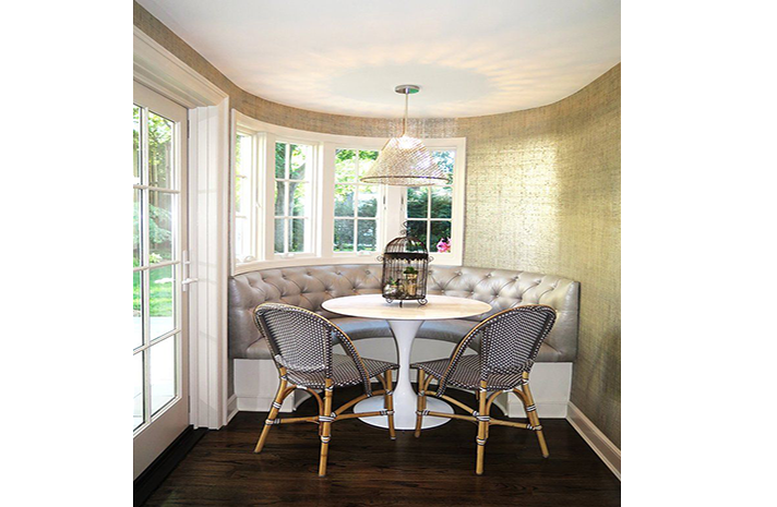 There is a table and chairs in the corner of the room.
