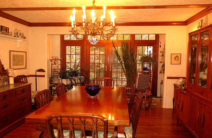 A dining room with a table and chairs and a chandelier