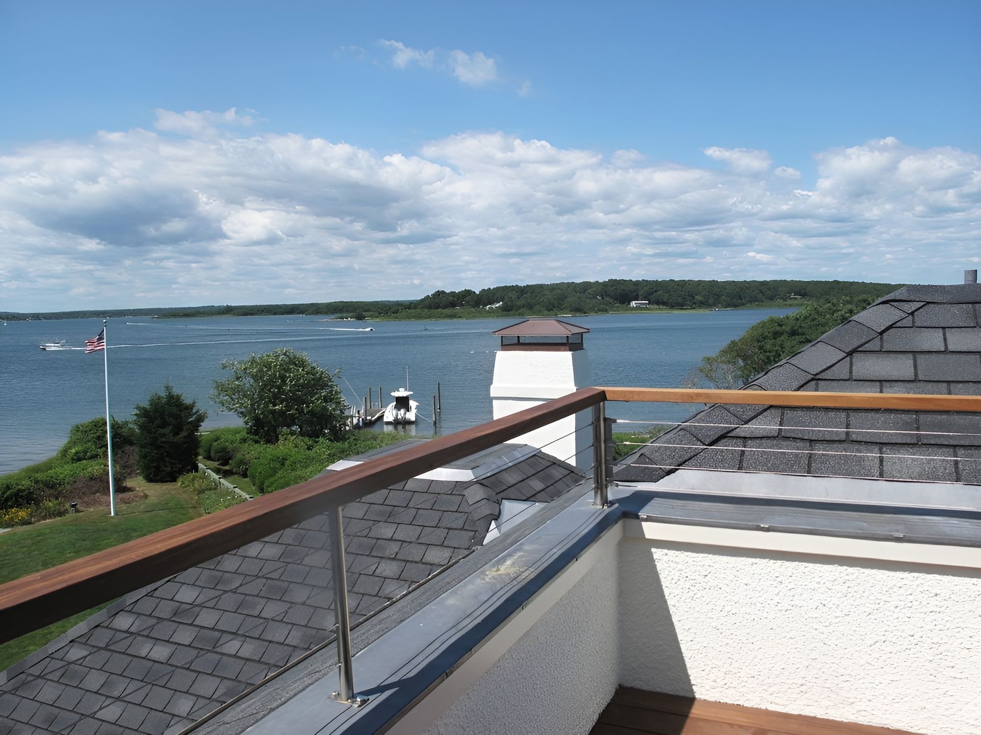 A balcony with a view of a body of water
