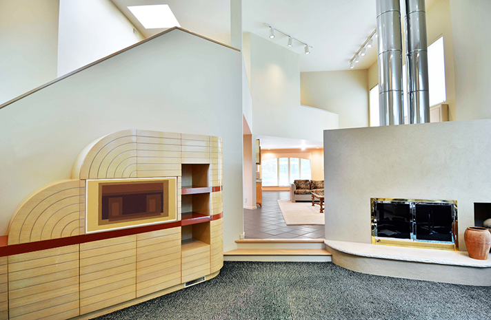 A living room with a fireplace and stairs