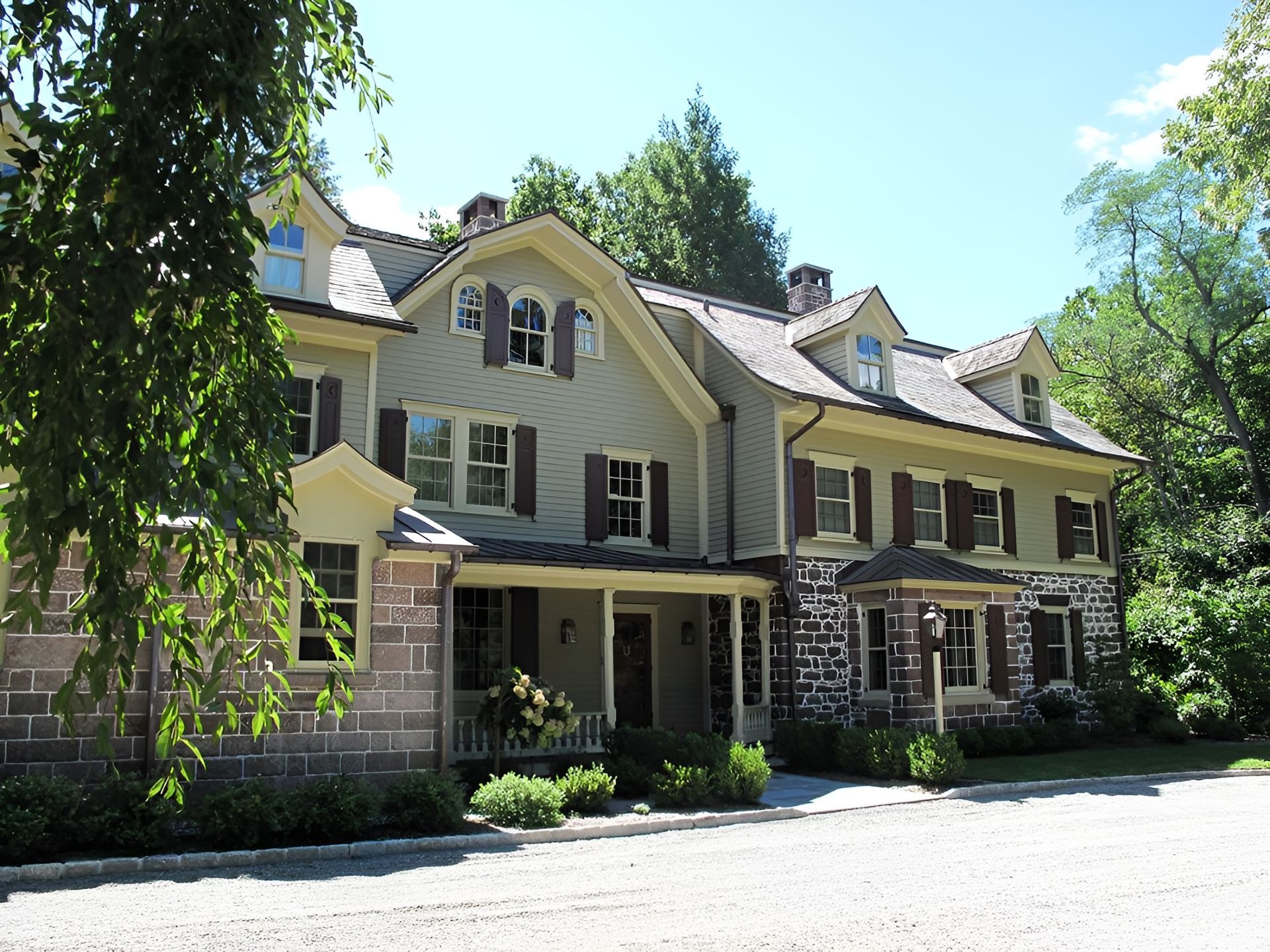 A large house with a lot of windows and shutters