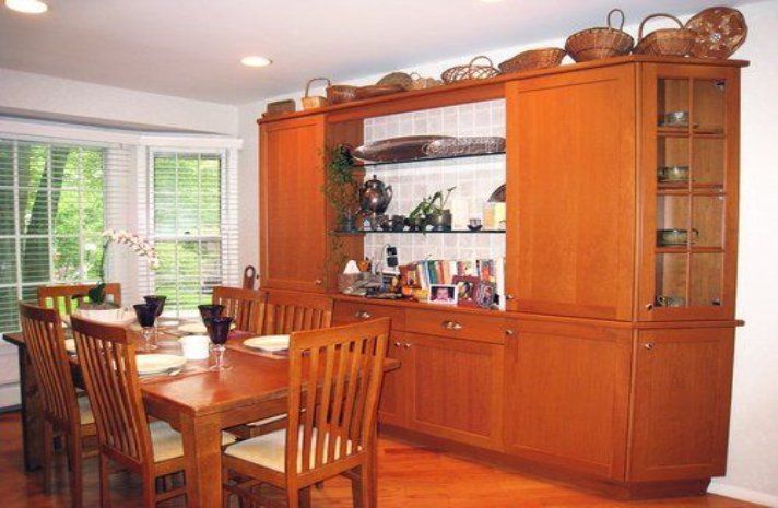 A dining room with a table and chairs and a hutch