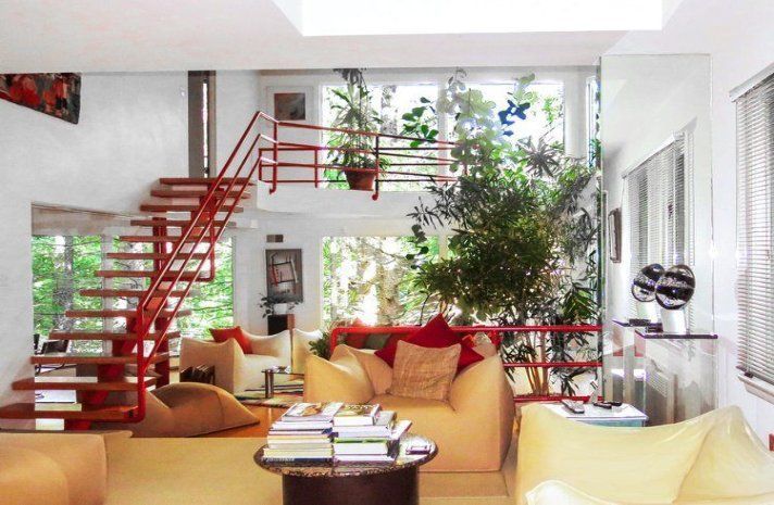 A living room with a staircase leading up to the second floor