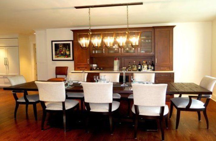 A dining room with a table and chairs and a bar