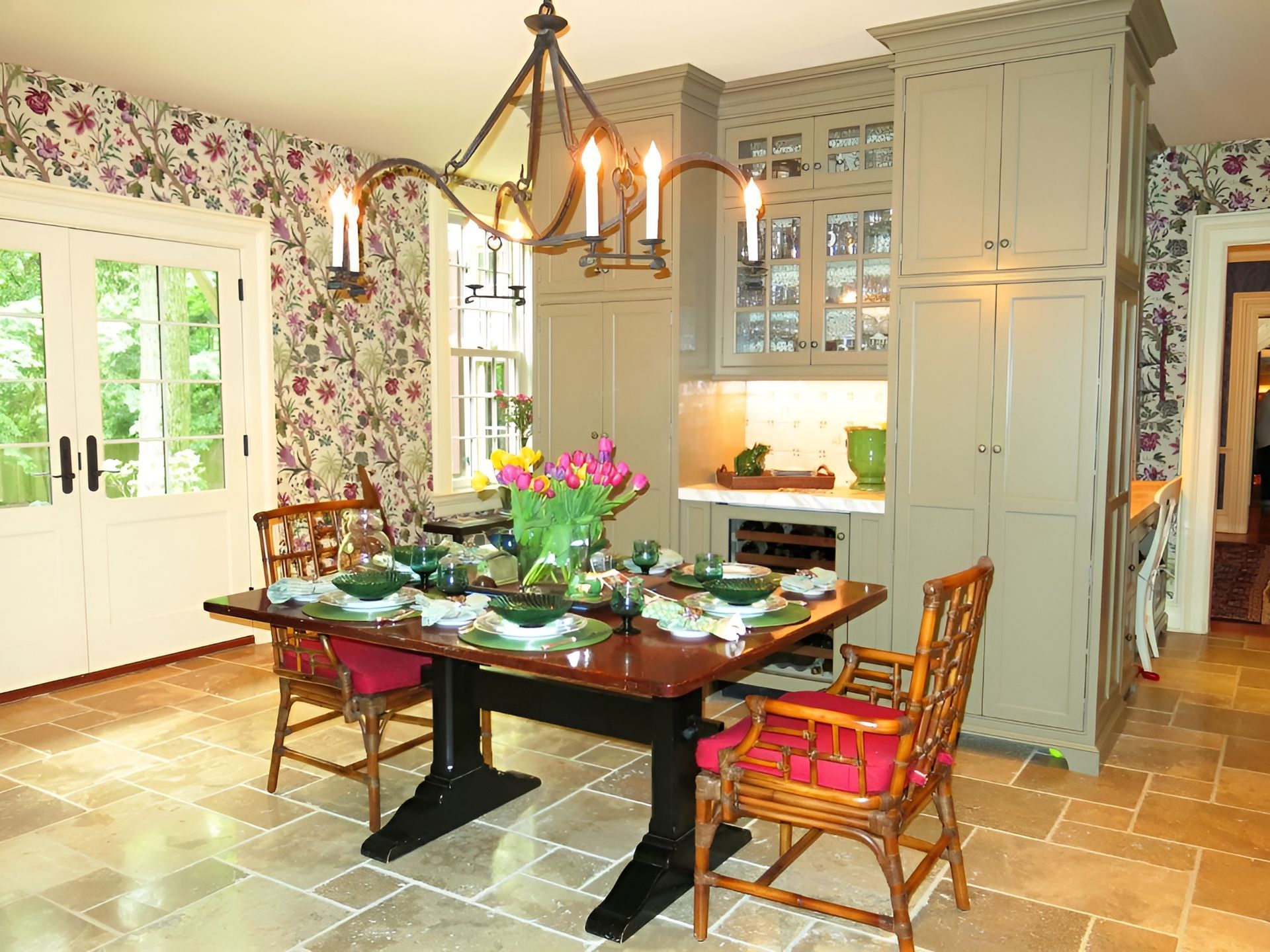 A dining room with a table and chairs and a chandelier