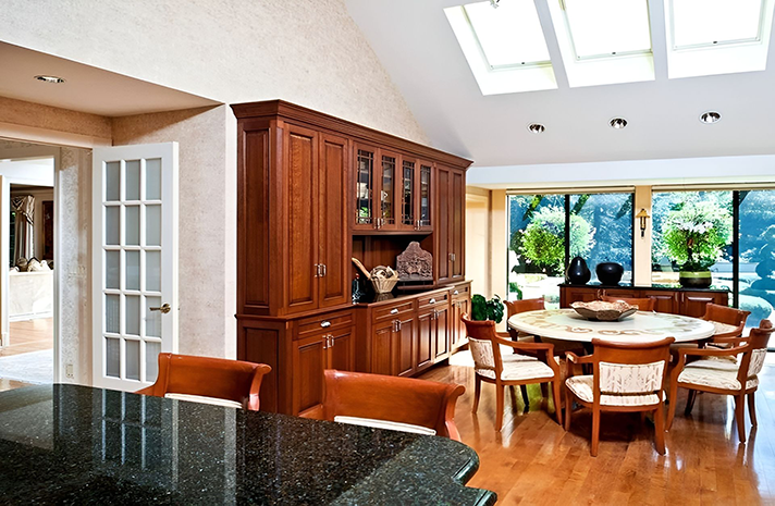 A dining room with a round table and chairs