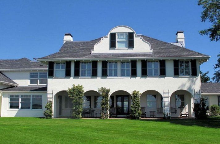 A large white house with black shutters on the windows