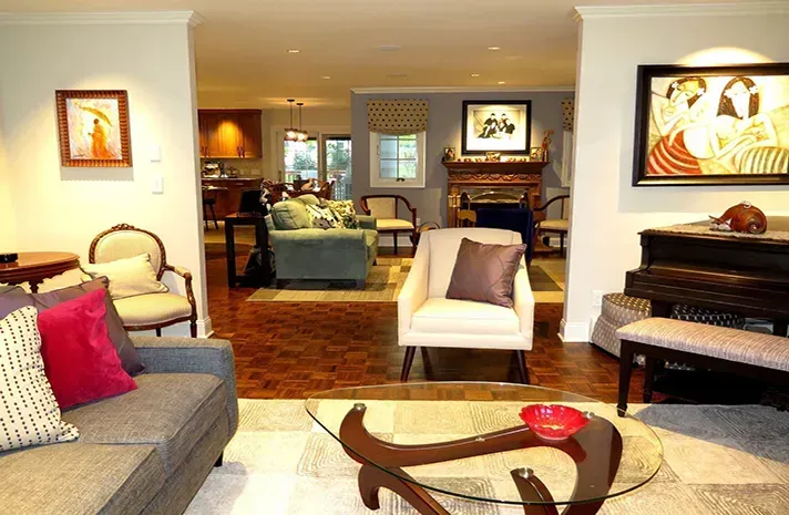 A living room with a couch a chair a coffee table and a piano