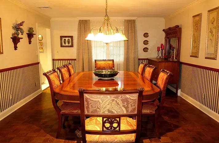 A dining room with a long table and chairs