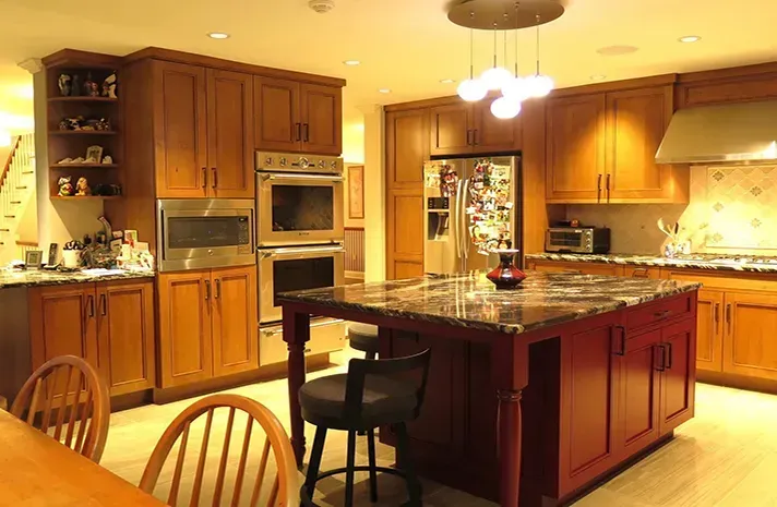 A kitchen with wooden cabinets and granite counter tops