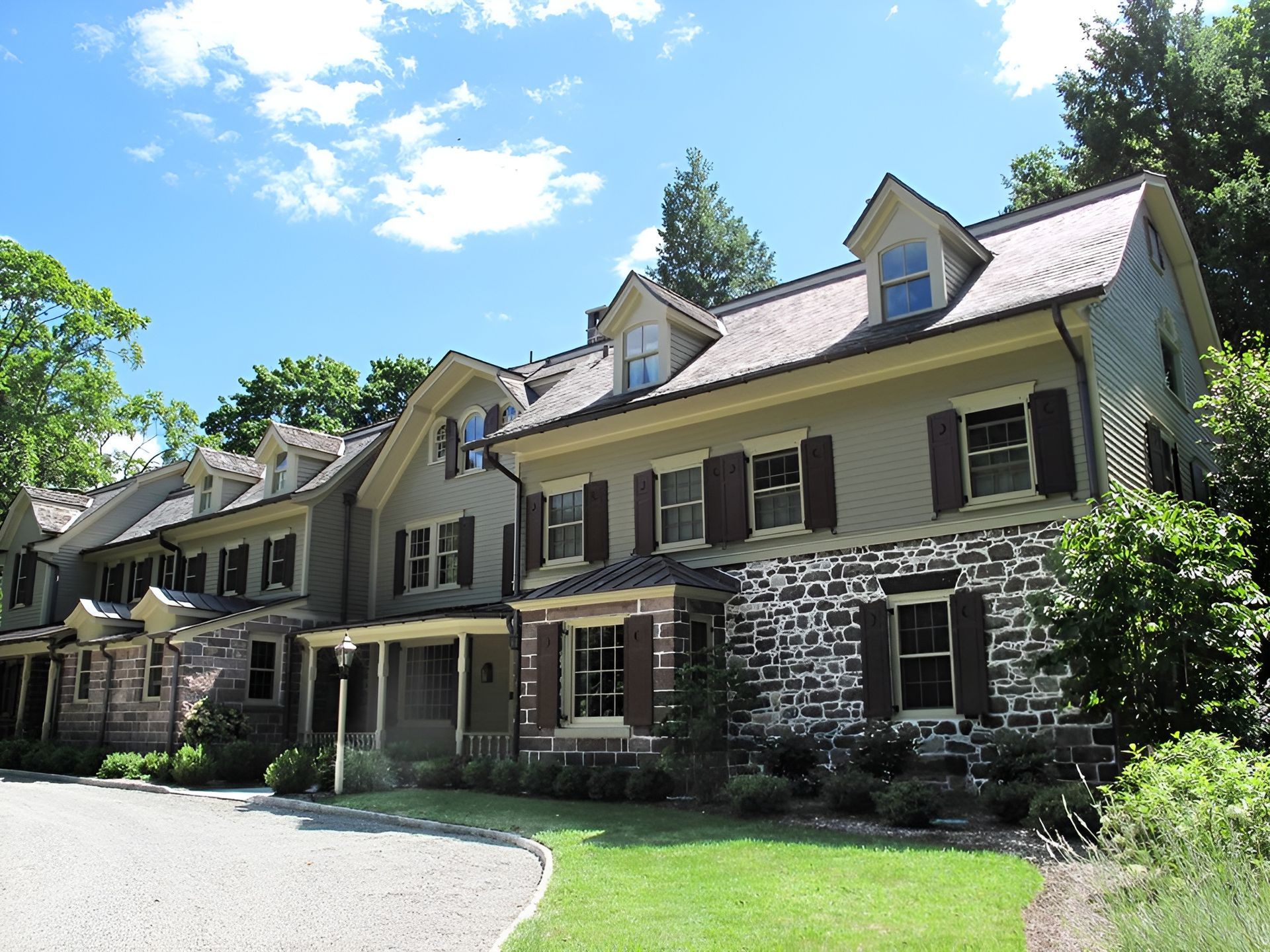 A large house with a lot of windows and shutters