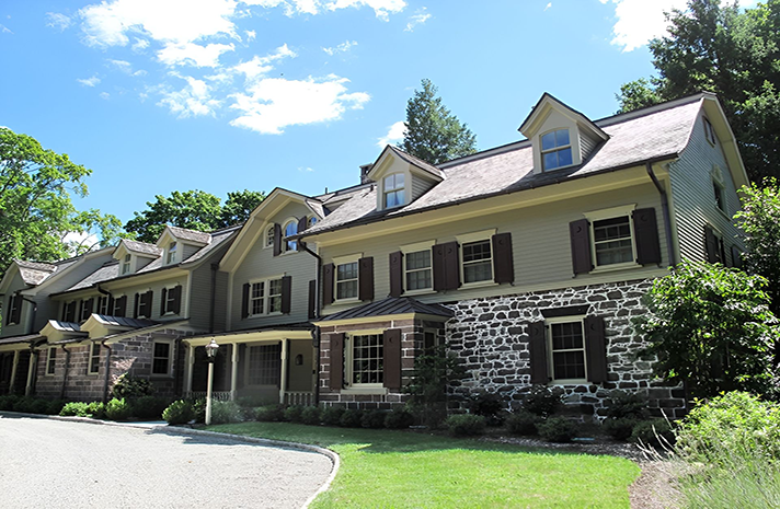 A large house with a lot of windows and shutters