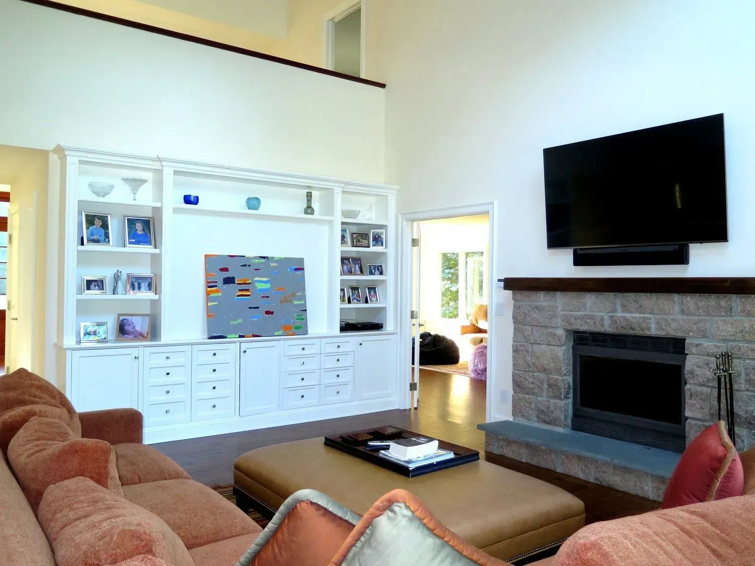 A living room with a fireplace and a flat screen tv