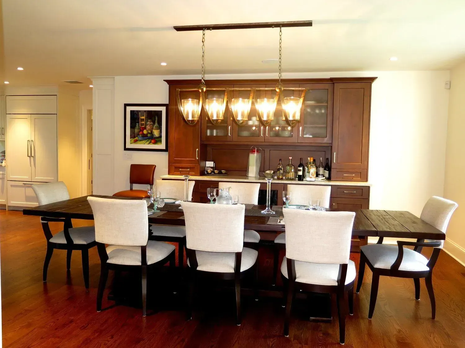 A dining room with a large table and chairs