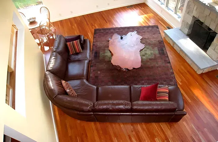 An aerial view of a living room with a couch and rug