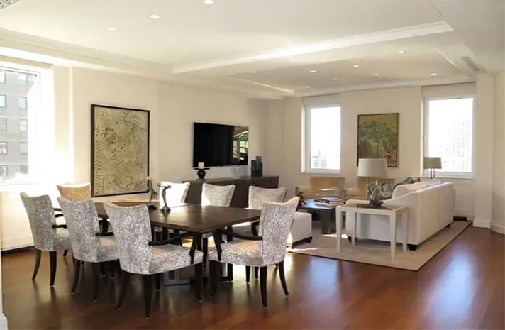 A living room with a dining table and chairs