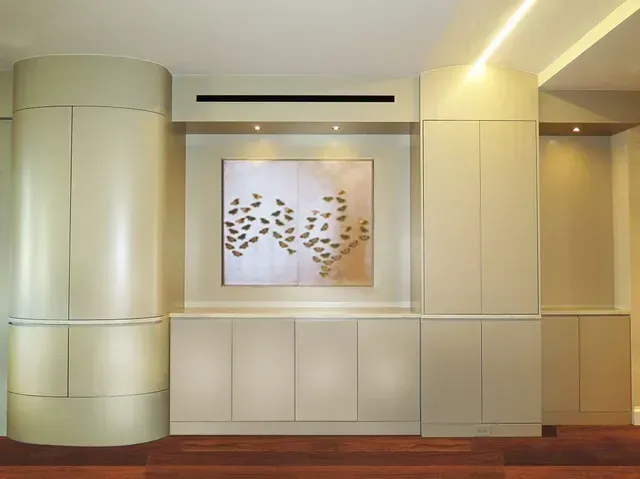 A room with white cabinets and a painting on the wall