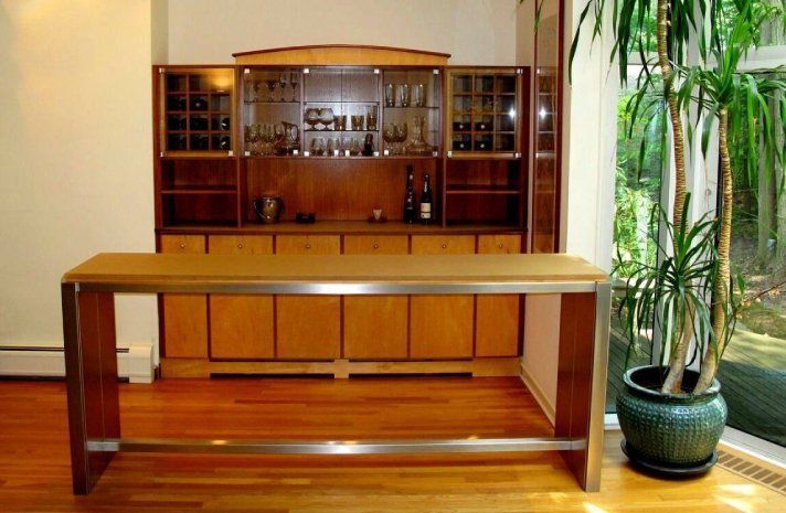 A wooden table in a room with a potted plant