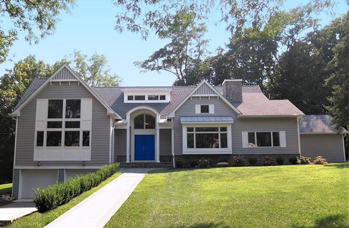 A large house with a blue door and white trim