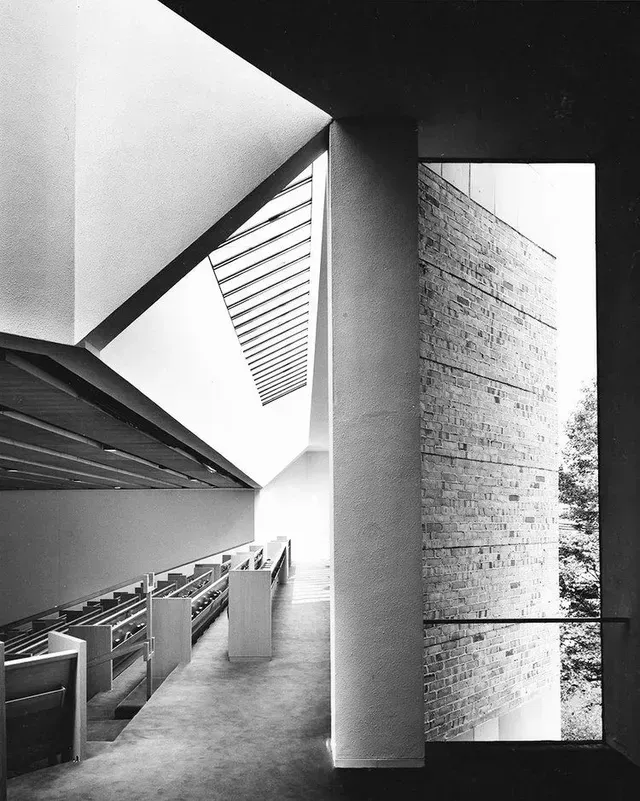 A black and white photo of a library with a large window