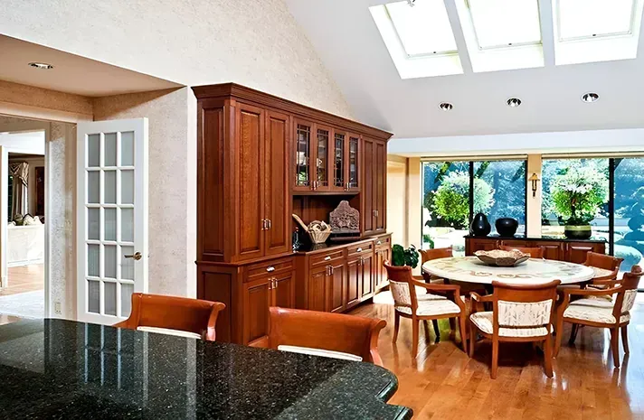 A dining room with a round table and chairs
