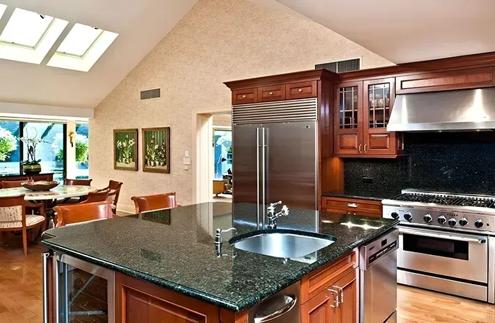 A kitchen with granite counter tops and stainless steel appliances
