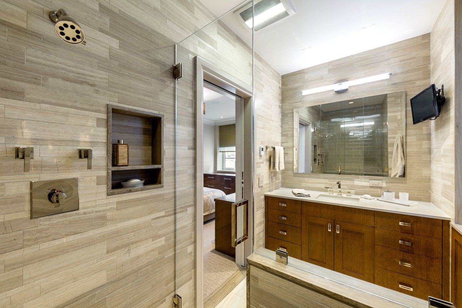 A bathroom with a walk in shower , sink , and mirror.