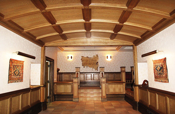 A hallway in a building with a wooden ceiling