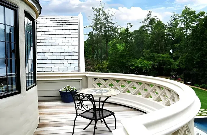 A balcony with a table and chairs on it